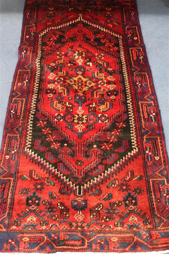 A Hamadan red and blue ground rug, 203cm x 92cm